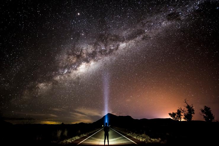 Sterngucker mit Stirnlampe, der zur Milchstraße aufschaut © Tourism and Events Queensland/Sean Scott