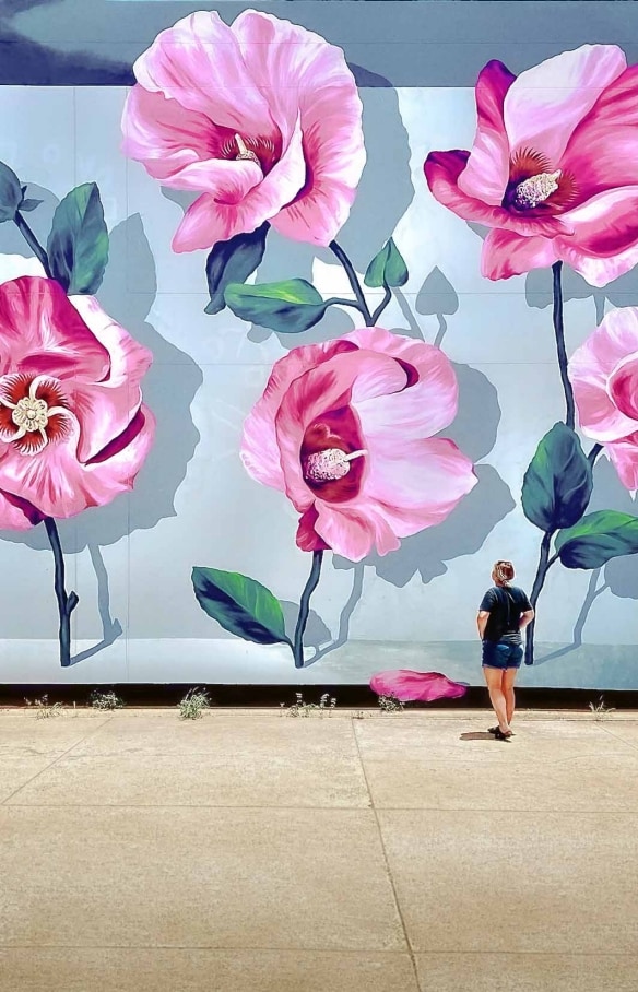 Girl wanders by street art in Darwin © Tourism Australia