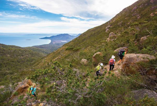 Woman walking the Freycinet Experience Walk in Freycinet National Park © Friendly Beaches Lodge / Great Walks of Australia