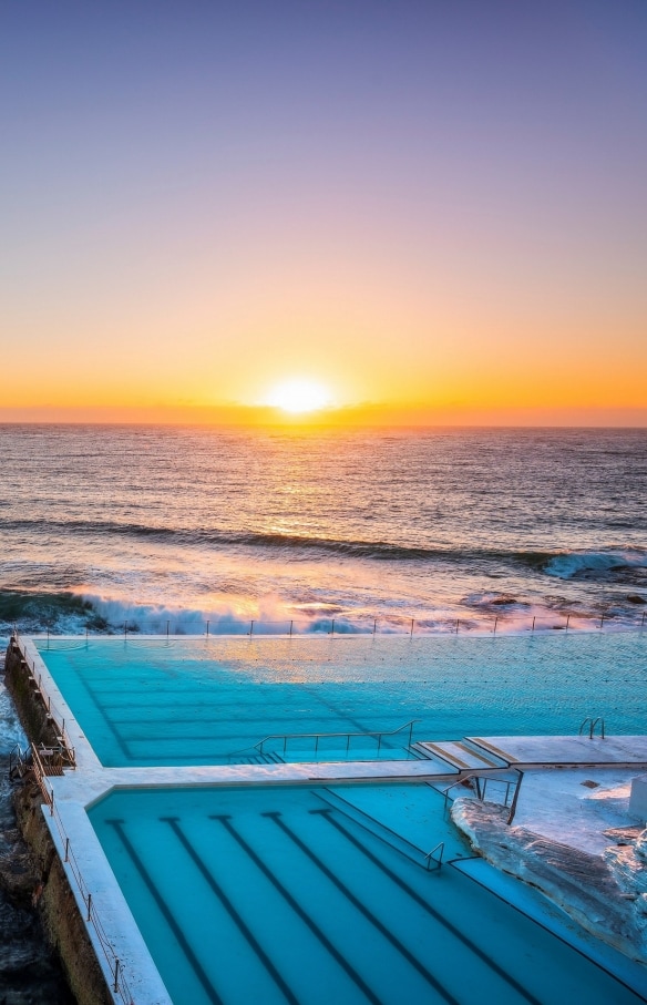 Morning sun rising over Bondi Icebergs, Bondi Beach © Destination NSW