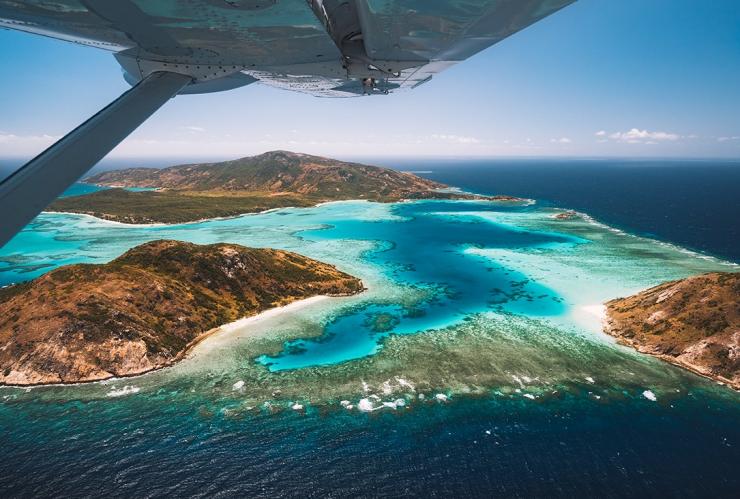 Aerial view out of plane window over Lizard island © Tourism Australia