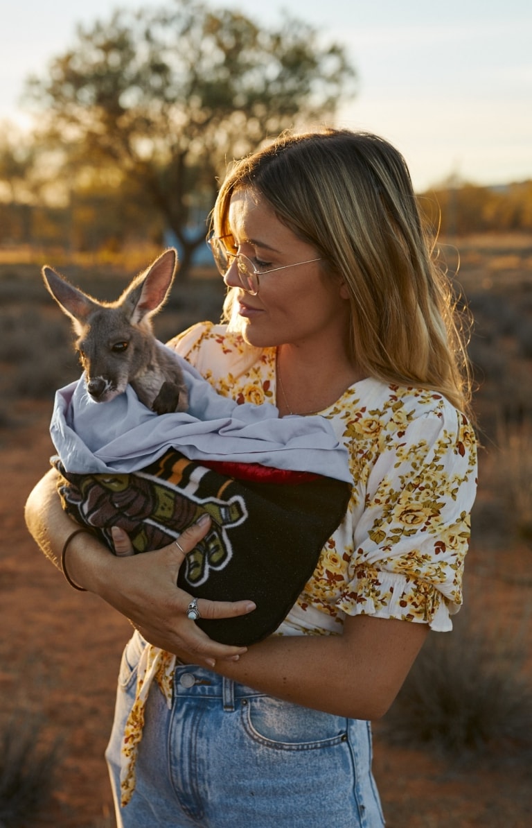 Holding a Baby Kangaroo at The Kangaroo Sanctuary, Alice Springs, NT © Tourism NT/Matt Cherubino 2019