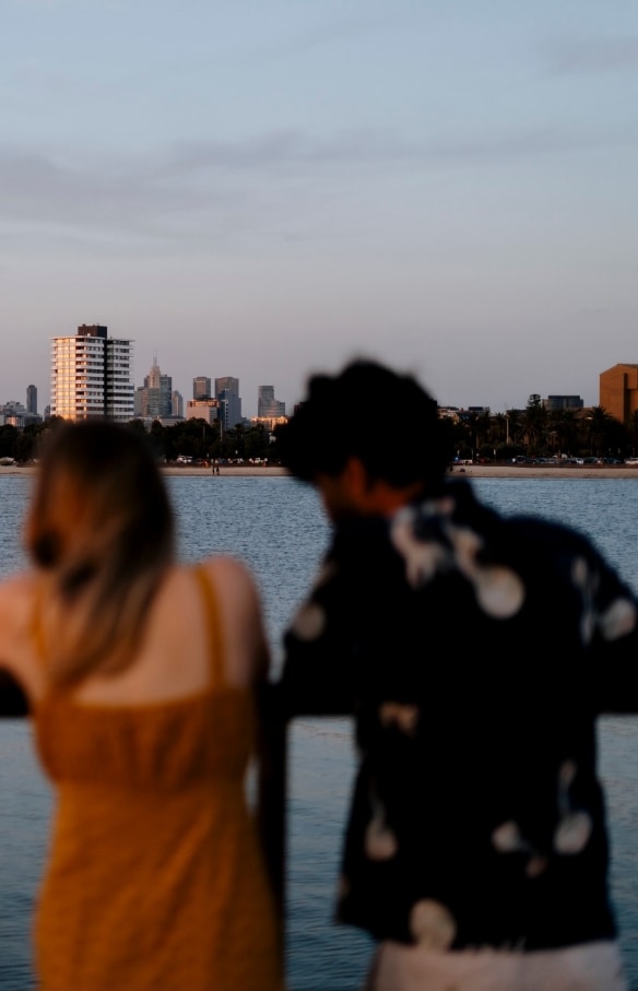 A man and woman admiring the distant view of the city from St Kilda Pier, Melbourne, Victoria © Visit Victoria