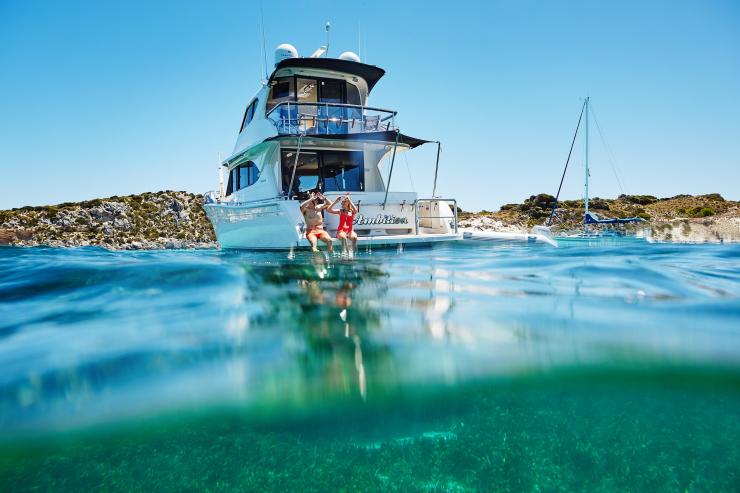 A man and woman wearing snorkels and preparing to slide off the back of a boat into clear waters off Rottnest Island, Western Australia © Tourism Western Australia A man and woman wearing snorkels and preparing to slide off the back of a boat into clear waters off Rottnest Island, Western Australia © Tourism Western Australia