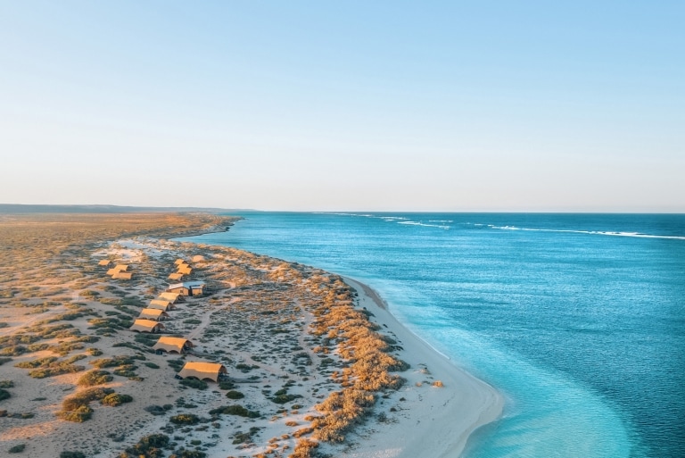 Aerial view of Sal Salis luxury accommodation amid the sand dunes on the coast of the bright blue waters of Ningaloo Reef, Western Australia © Sal Salis Ningaloo Reef