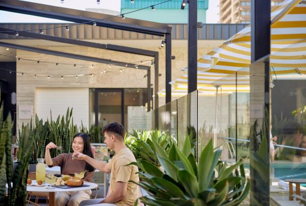 A couple at a table amid a rooftop garden, Hibiscus, Brsbane, Queensland © Brisbane Economic Development Agency