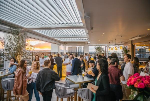 A crowd of people enjoying a semi-undercover rooftop bar, Iris Rooftop Bar, Brisbane, Queensland © Brisbane Economic Development Agency