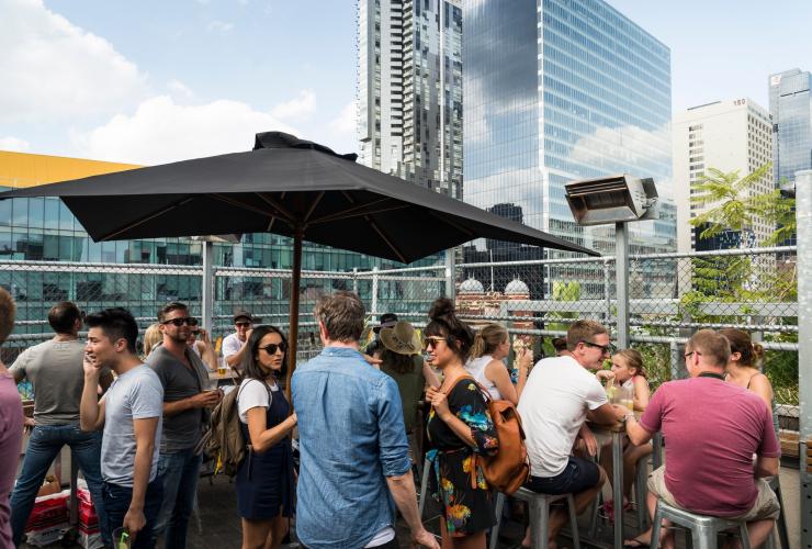 Group of people at Rooftop Bar at Curtin House in Melbourne © Visit Victoria