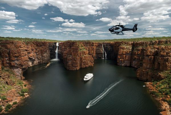 Ship and helicopter near waterfalls, True North, The Kimberley, WA © True north Adventure Cruises