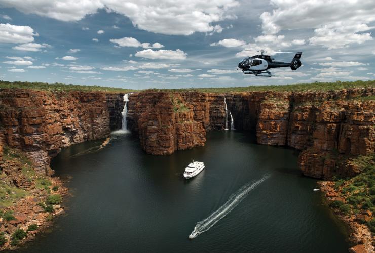 Ship and helicopter near waterfalls, True North, The Kimberley, WA © True north Adventure Cruises