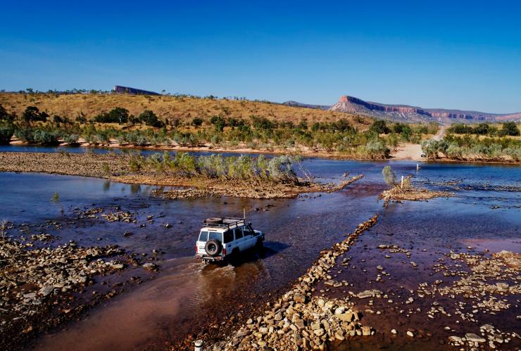 Aerial view of a 4WD travelling through a shallow river at the Pentecost River Crossing in Western Australia © Tourism Western Australia 
