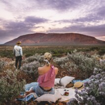 Couple enjoying a picnic with a view of Mount Augustus © Australia’s Golden Outback
