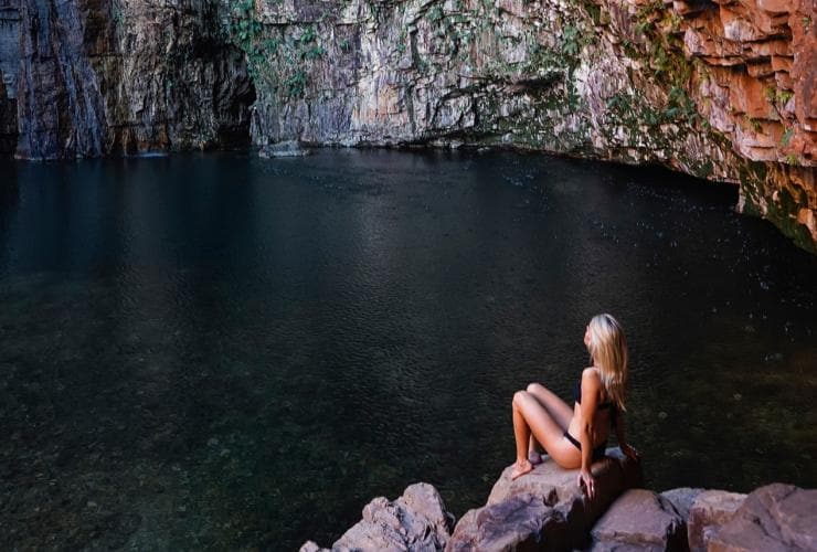 Woman sitting on rock at Emma Gorge © Tourism Australia