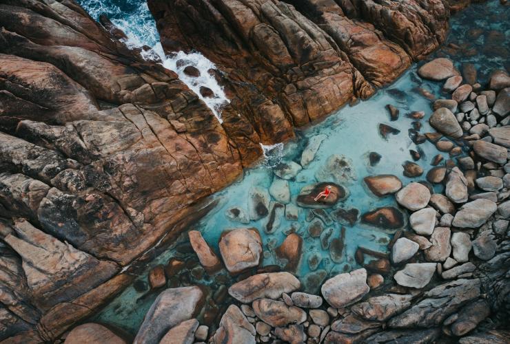 Aerial view of a woman sitting on a rock in Injidup Natural Spa © Jarrad Seng / Tourism Western Australia