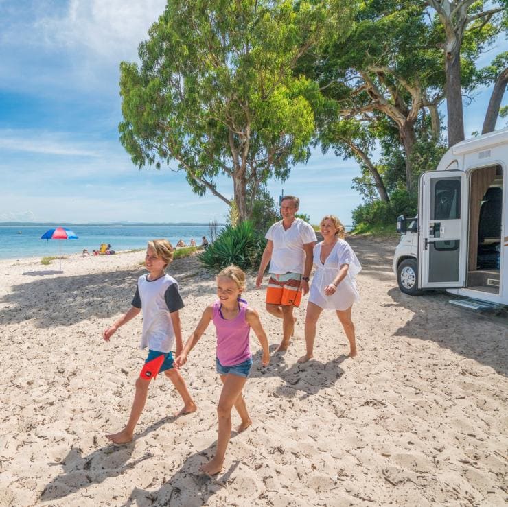 Family and their campervan parked alongside Tilligerry Creek near BIG4 Koala Shores Port Stephens Holiday Park © Destination NSW