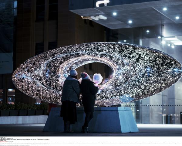 A group of people gathered around a sparkling sculpture at night outside the Museum of Contemporary Art, Sydney, New South Wales © Destination NSW