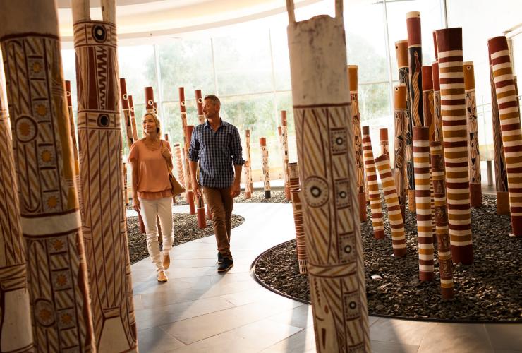 Couple strolls through an Aboriginal artwork exhibit at the National Gallery of Australia in Canberra © Tourism Australia