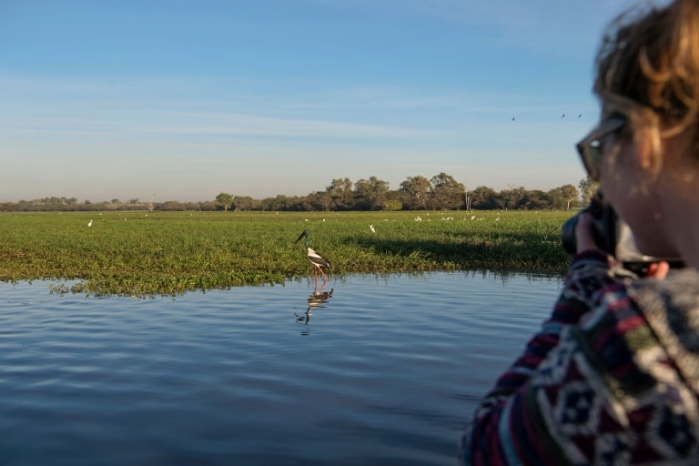 Woman with camera photographs birds in Kakadu National Park in the Northern Territory  © Tourism NT/Shaana McNaught