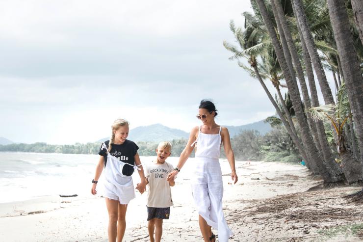 Family walking on the beach at Palm Cove © Tourism and Events Queensland