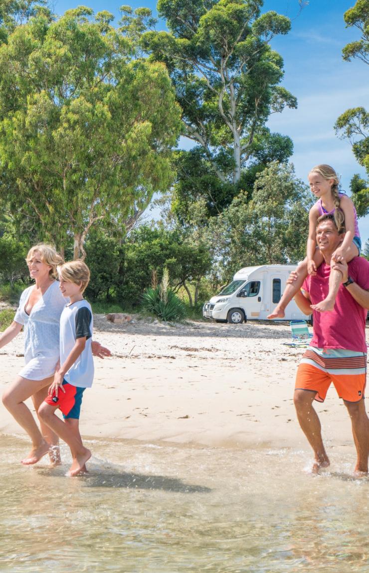 Family strolling alongside Tilligerry Creek © Destination NSW 