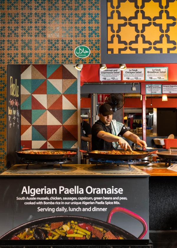 A cook stirring a huge pan of paella at Le Souk, Adelaide, South Australia © Lewis Potter