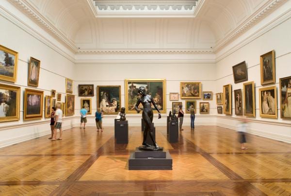People admiring an art gallery filled with paintings and sculptures at the Art Gallery of New South Wales, Sydney, NSW © Art Gallery of New South Wales