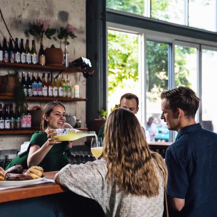 Bartender serves patrons at Oddio in Bowden © @josiewithers / @oddiobowden