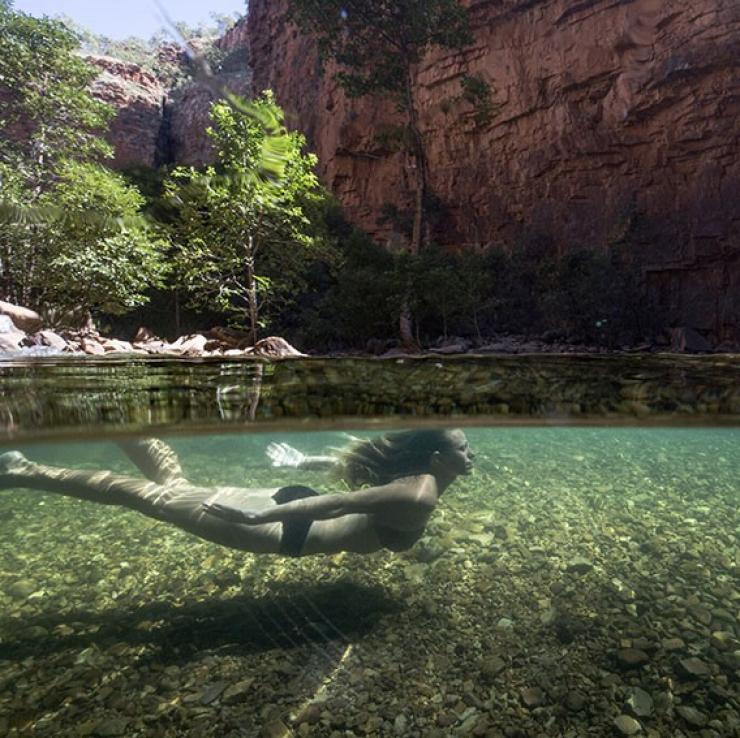 A woman swimming in a waterhole in El Questro Wilderness Park in The Kimberley © Tourism Western Australia