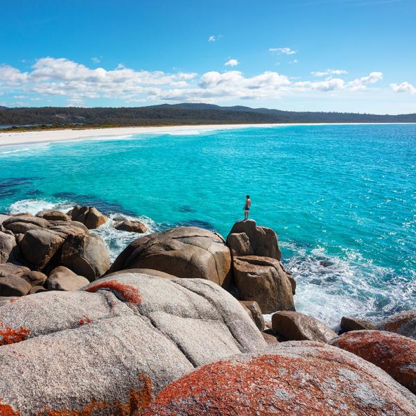 Man on rock at Sloop Reef near the Bay of Fires © Tourism Australia/Daniel Tran