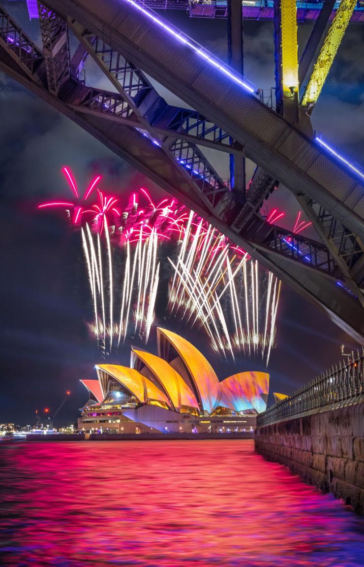 Fireworks erupting over the Sydney Opera House with the Sydney Harbour Bridge visible in the foreground., Vivid Sydney, Sydney Opera House, Sydney, New South Wales © Tourism Australia