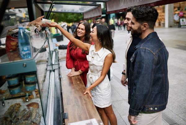 A group of friends ordering food from a street stall along Rundle Mall, Adelaide, South Australia © South Australian Tourism Commission