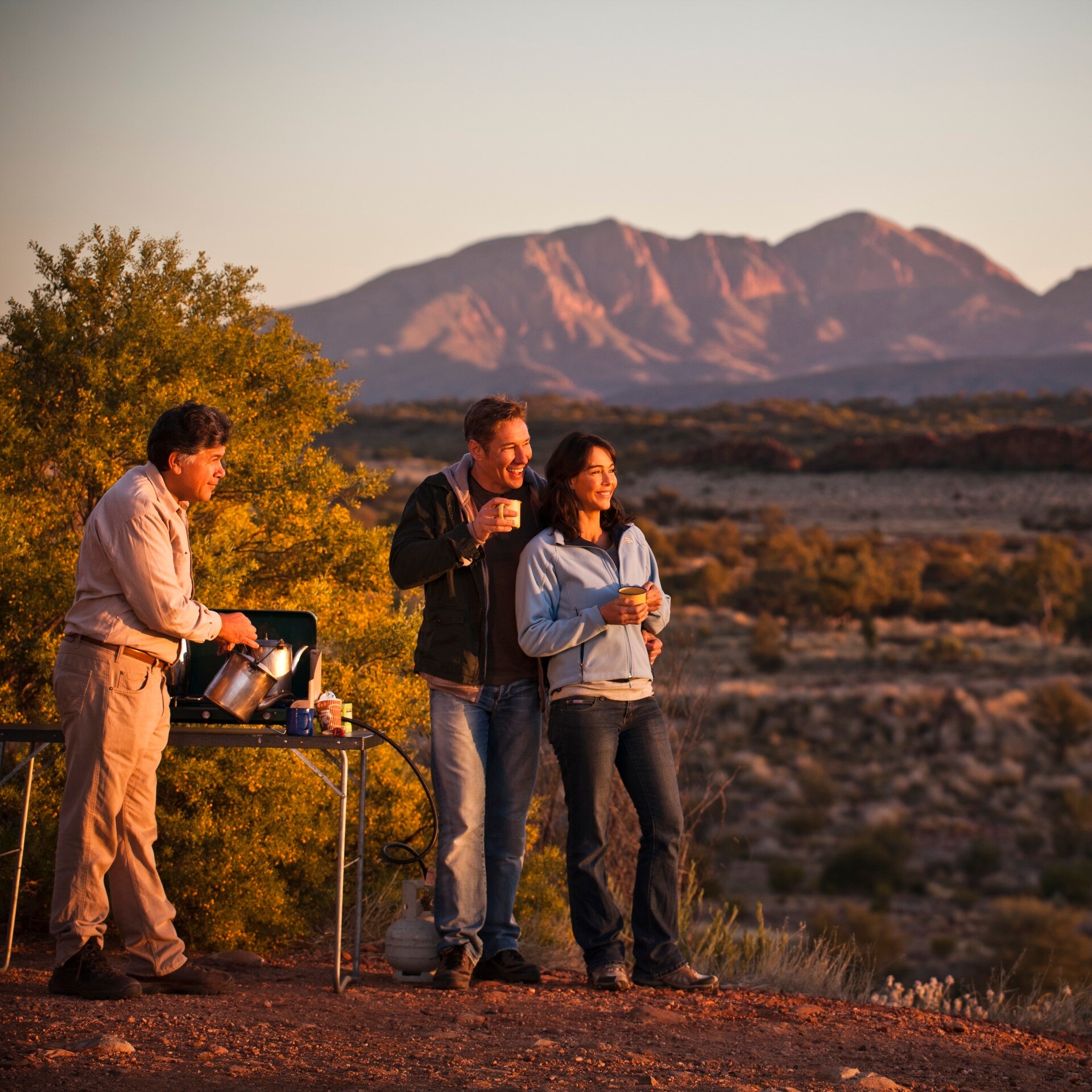 Couple admire the outback landscape near Alice Springs © James Fisher/Tourism Australia