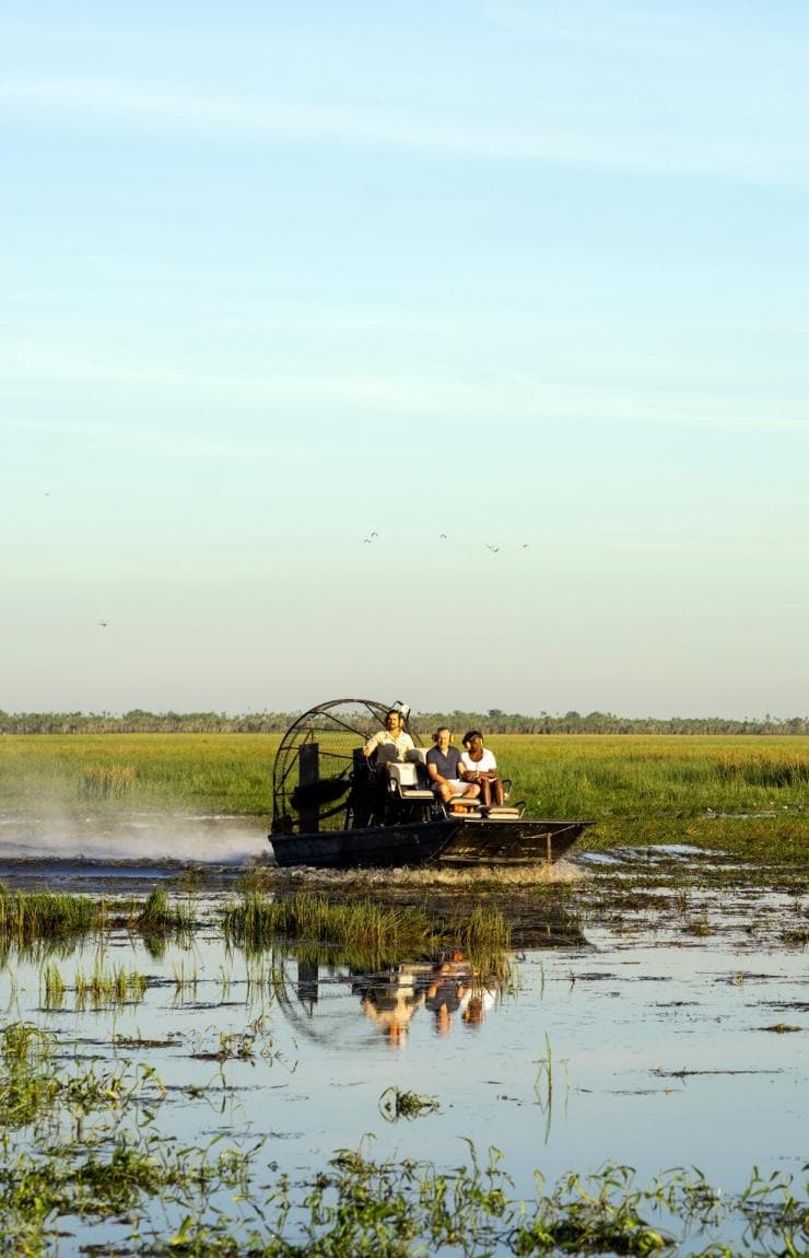 A group of people on an air boat driving through wetlands, Bamurru Plains, Kakadu, Northern Territory © Tourism NT/KWP!/Shaana McNaught