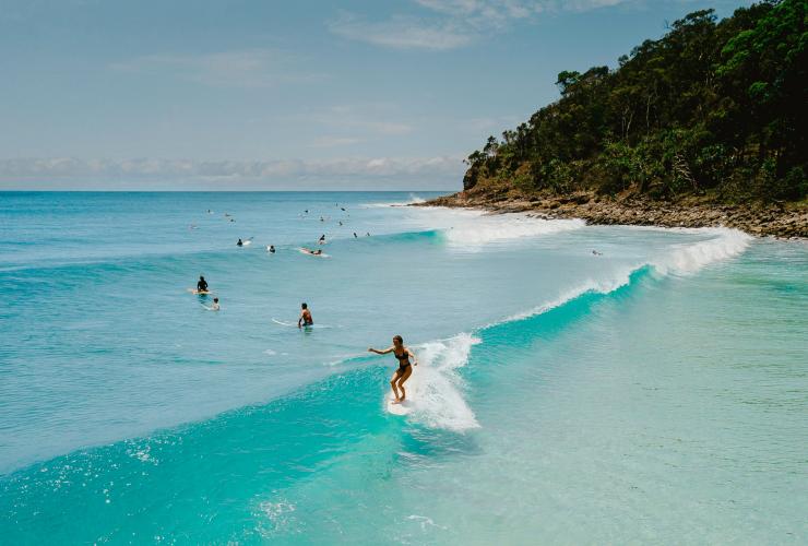 Surfer catching a wave at Noosa National Park, QLD © Tourism and Events Queensland