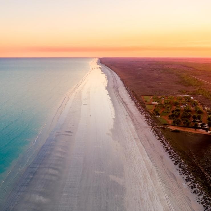 Aerial view over Eighty Mile Beach at sunrise © Australia’s North West, CJ Maddock (@awaywithcj)