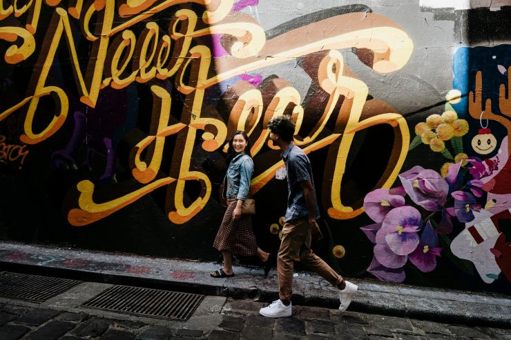 Two people wandering beside the graffiti-lined walls of Hosier Lane in Melbourne, Victoria © Tourism Australia Two people wandering beside the graffiti-lined walls of Hosier Lane in Melbourne, Victoria © Tourism Australia
