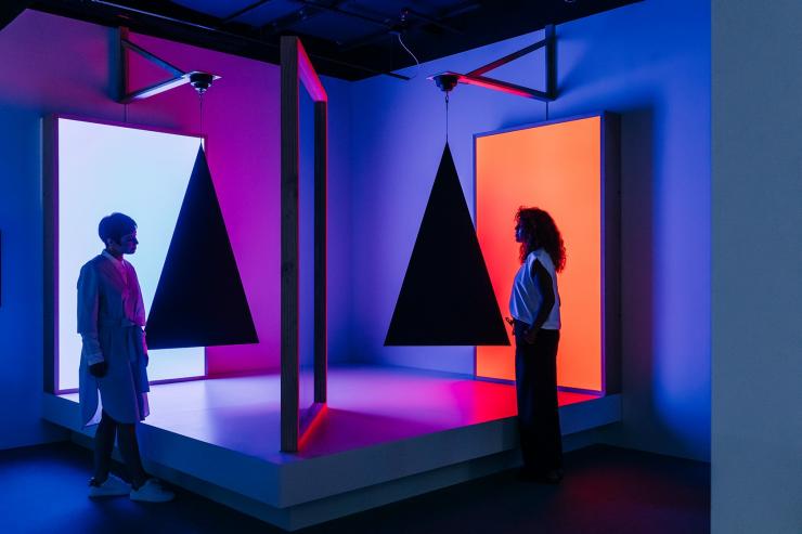 Two people admiring an art installation of bold colours, lights and shapes at ACMI in Melbourne, Victoria © ACMI Two people admiring an art installation of bold colours, lights and shapes at ACMI in Melbourne, Victoria © ACMI