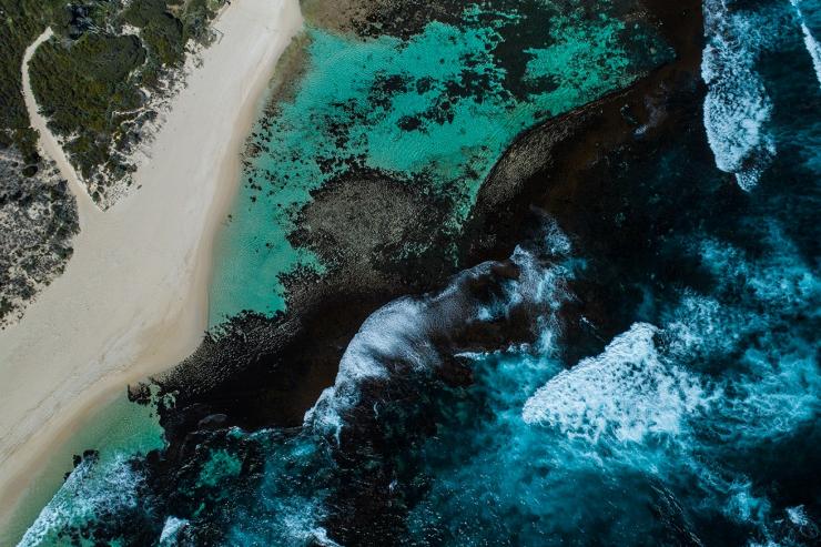 Aerial view of blue waves crashing on the shoreline at Yallingup Beach, Yallingup, Western Australia © Tourism Australia