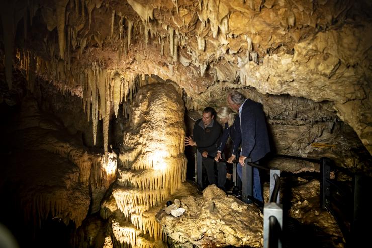 A couple standing underground among the formations of Ngilgi Cave with a local Aboriginal tour guide from Koomal Dreaming, Margaret River, Western Australia © Archie Sartracom