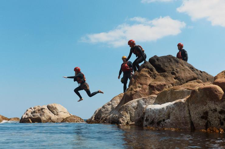 A group of people jumping from rocks into a calm ocean pool with Margaret River Adventure CO., Margaret River, Western Australia © Margaret River Adventure Co.