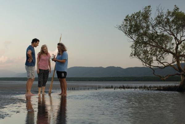 Couple learning how to hunt mud crabs during a Kuku Yalanji Cultural Habitat Tour on Cooya Beach © Tourism and Events Queensland