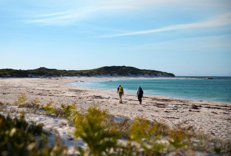 Hikers walking on the beach as part of the Wulkalina Walk © The Wukalina Walk