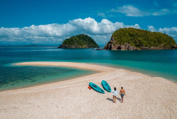 Aerial view of a couple walking along the beach, QLD © Tourism and Events Queensland