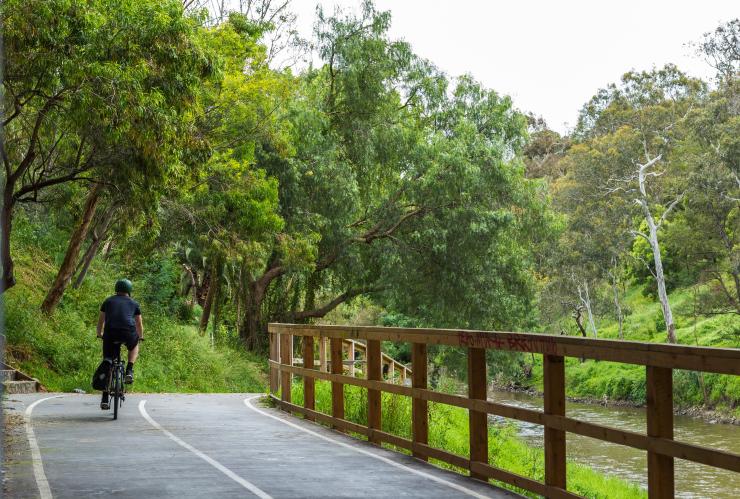 Cyclist rides on trail near Abbotsford Convent in Melbourne © Roberto Seba