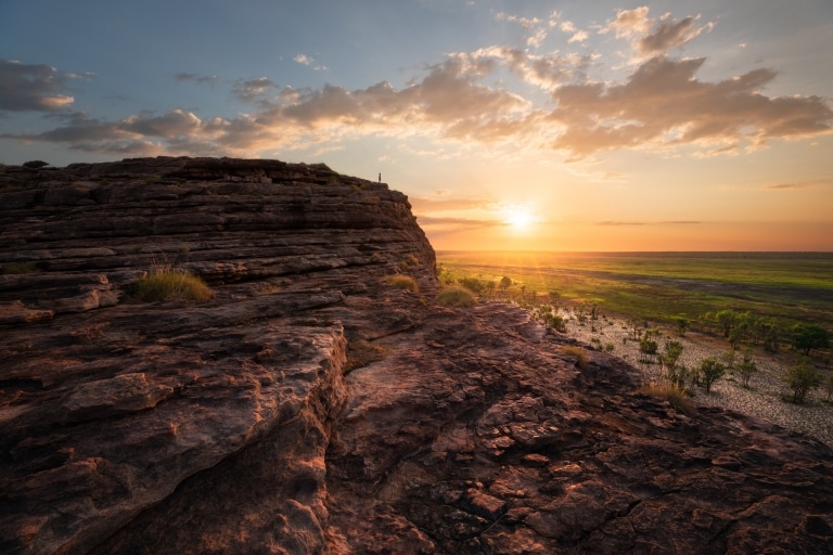 Man standing on the top of the rock in Ubirr, Kakadu National Park © Tourism NT/Daniel Tran