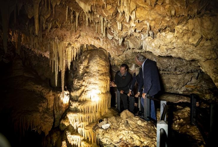 Two travellers with a tour guide in caves on a Koomal Dreaming tour © Archie Sartracom