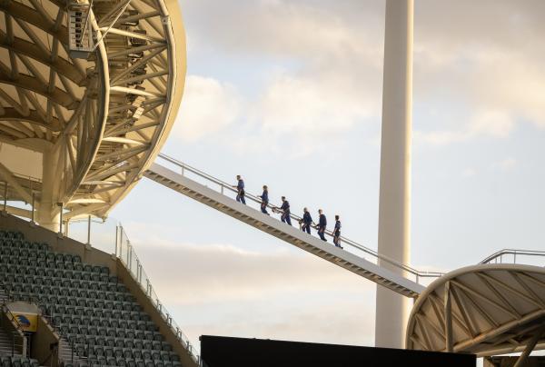 A group of people walking along a staircase on the roof of the Adelaide Oval during a RoofClimb experience, Adelaide, South Australia © Tourism Australia