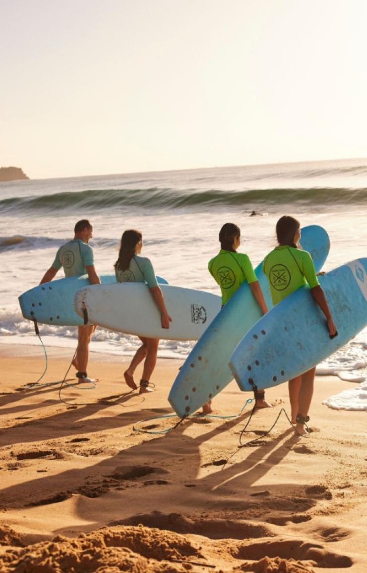 Students enjoying a learn to surf experience with Central Coast Surf Academy, Avoca Beach, New South Wales © Destination NSW