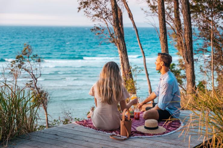Sunset picnic overlooking the Little Cove Beach, Noosa, Queensland © Tourism and Events Queensland