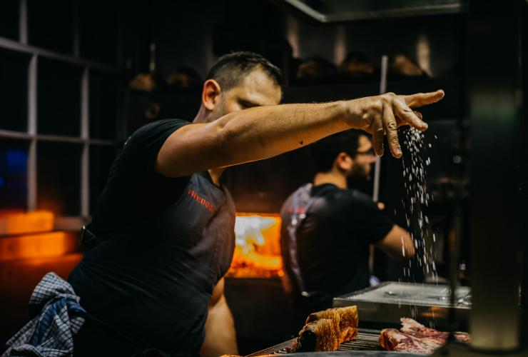Chef cooking meat at Firedoor restaurant in Sydney © Firedoor/Nikki To